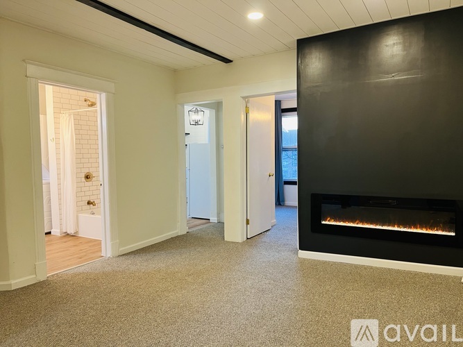 A room with a fireplace and a carpeted floor.