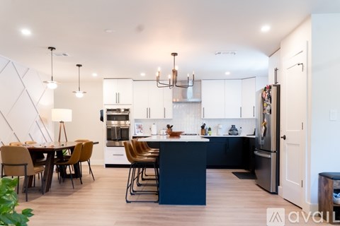 A modern kitchen with a dining table and chairs.