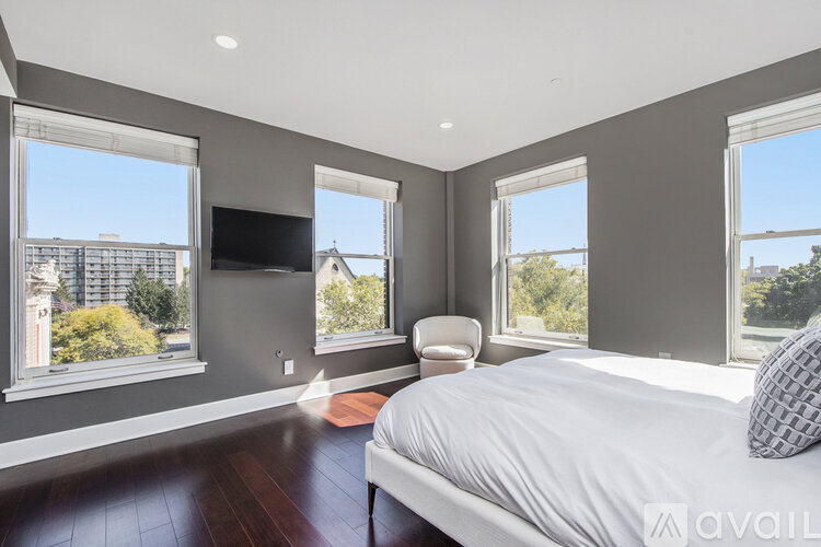 A bedroom with a large bed and a flat screen TV.