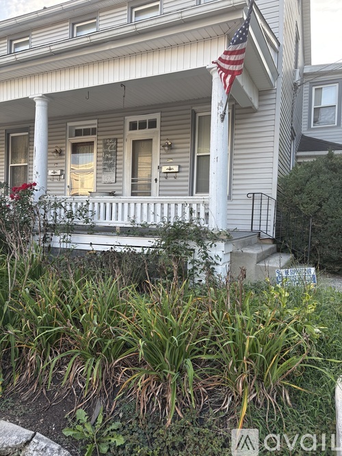 A house with a flag on the front porch.