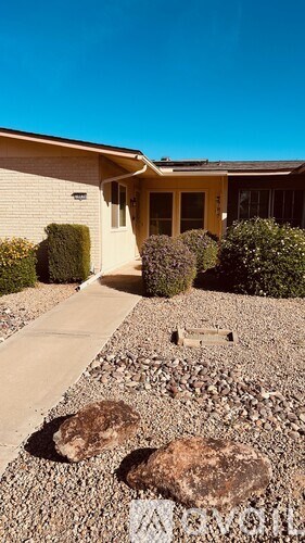 A house with a gravel path leading to the front door.