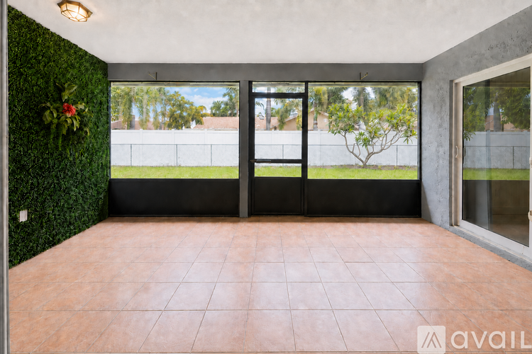 A room with a green wall and a black door.