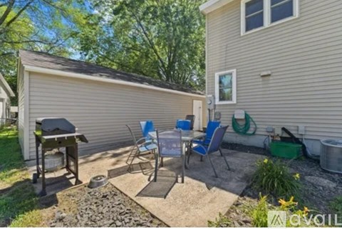 A backyard with a patio table and chairs.