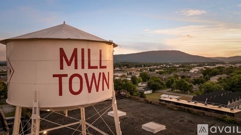 A large white water tower with the words "Mill Town" on it.