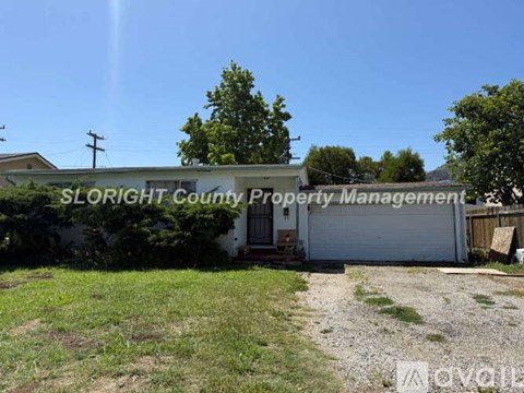 A sign for SLORIGHT COUNTY PROPERTY MANAGEMENT is on the side of a building.