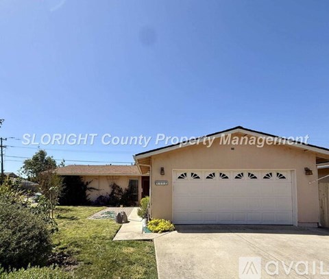 A house with a garage door and a sign that says "SLOUGHT County Property Management".