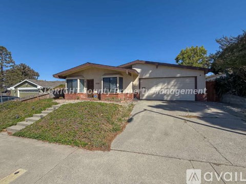 A house with a sign that says "Southport Property Management" in front of it.