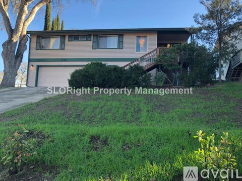 A house with the text "SLORight Property Management" in front of it.
