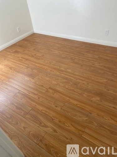 A room with wooden flooring and a logo that says "avaiL".