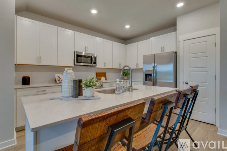 A kitchen with white cabinets and a white countertop.