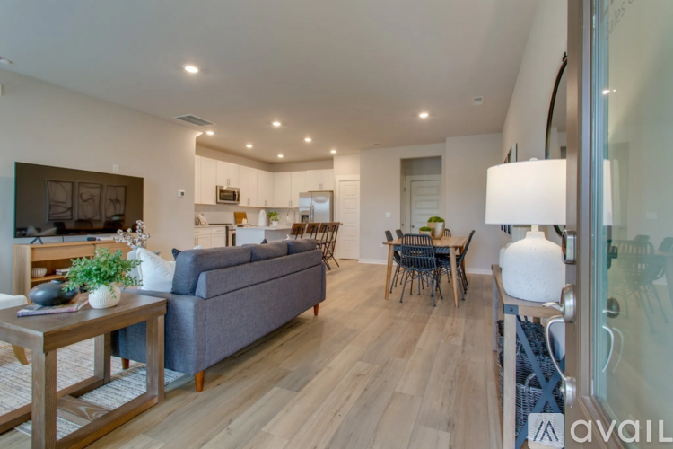A modern living room with a grey couch and a wooden coffee table.