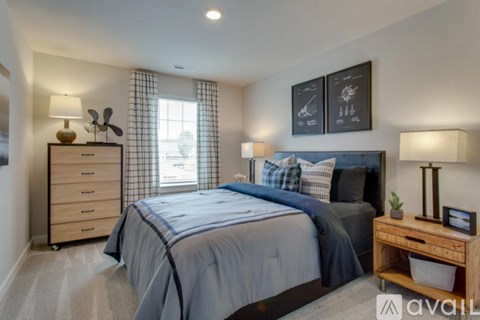 A bedroom with a large bed and a wooden nightstand.