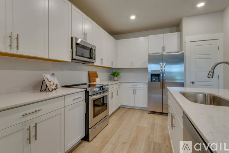 A kitchen with white cabinets and stainless steel appliances.