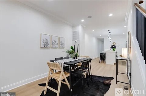 A dining area with a table and chairs is shown in the image.