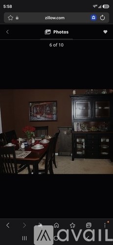 A dining room with a wooden table set for a meal.