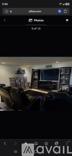 A living room with a couch and a television.