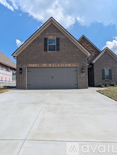 A house with a garage and a driveway in front.