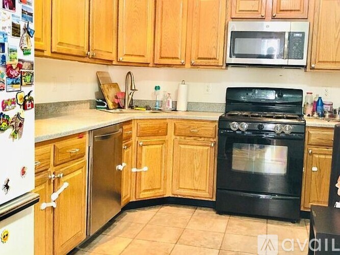 A kitchen with wooden cabinets and a black oven.
