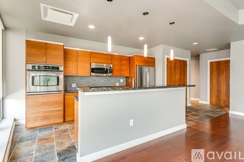 A modern kitchen with wooden cabinets and a white countertop.