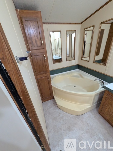 A bathroom with a tub and a wooden door.