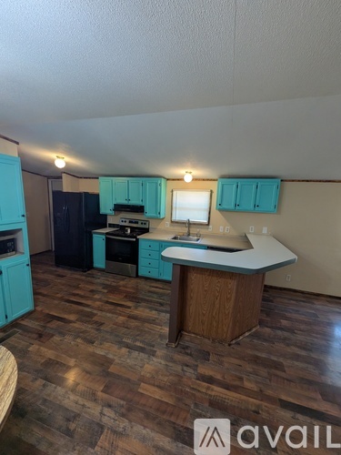 A kitchen with a wooden floor and a counter.