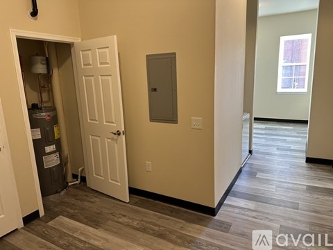 A room with a door open to a hallway.