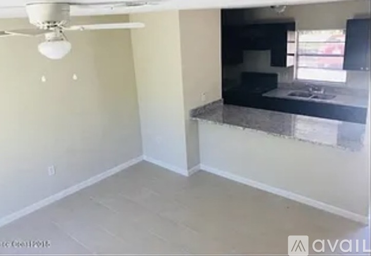A room with a fan and a countertop.