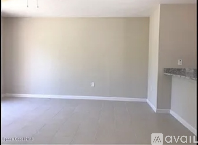 A room with a fireplace and a wall socket.