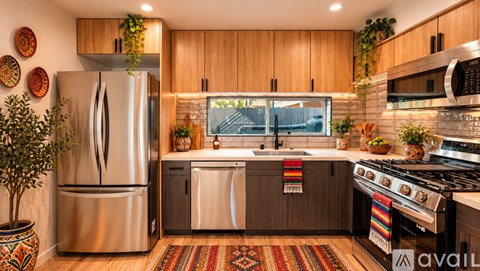 A kitchen with a refrigerator, stove, and sink.