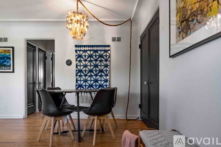 A dining room with a table and chairs.