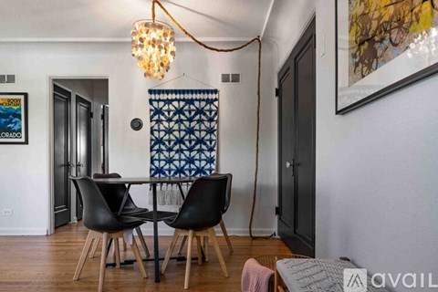 A dining room with a table and chairs.