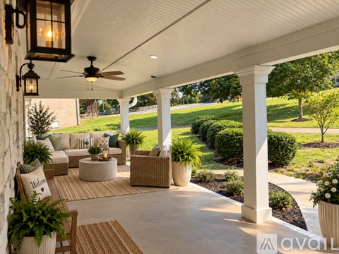 A patio with a white ceiling and a stone wall.