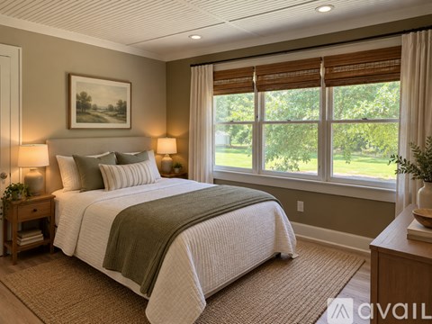 A bedroom with a large bed and a painting on the wall.