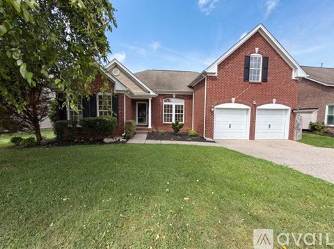A red brick house with a white garage door.