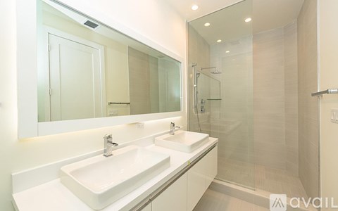 A bathroom with a white sink and a mirror.