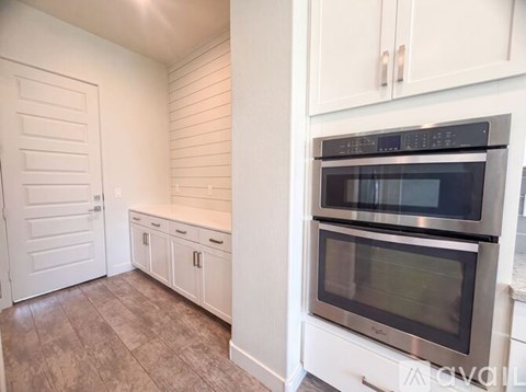 A kitchen with a stove top oven and microwave.