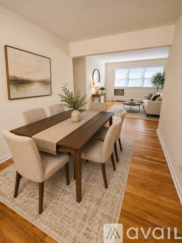 A dining room with a wooden table and chairs.