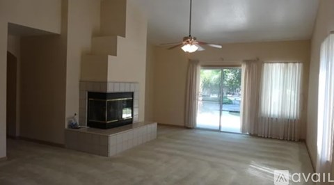 A living room with a fireplace and sliding glass doors.