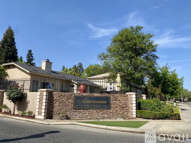 The image shows a building with a sign that reads "Americana Shores" in front of it.