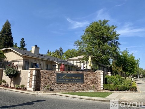 The image shows a building with a sign that reads "Americana Shores" in front of it.