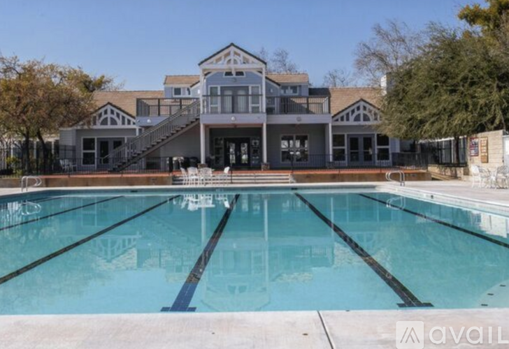 A large swimming pool in front of a multi-story building.
