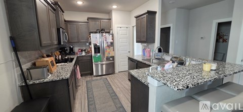A kitchen with granite countertops and stainless steel appliances.