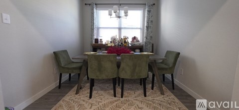 A dining room with a table set for six.