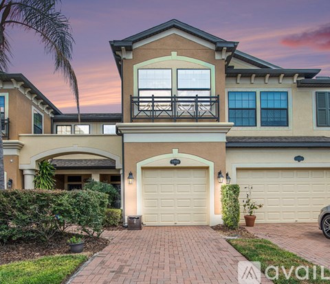 A two-story house with a balcony and a garage.