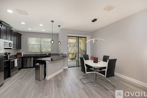 A modern kitchen with a dining table set up.