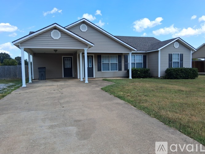 A house with a front yard and a driveway is available for rent.