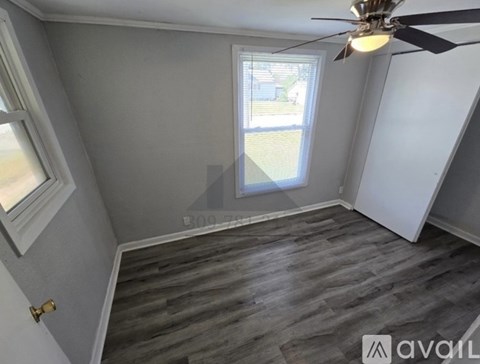 A room with a ceiling fan and a window.