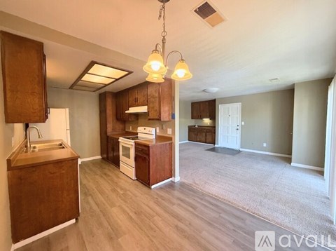 A kitchen area with wooden cabinets and a white oven.