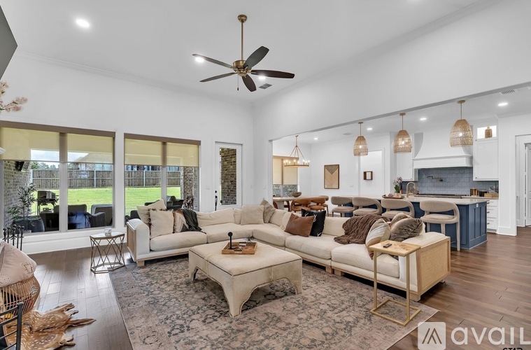 A spacious living room with a large sofa set and a coffee table.