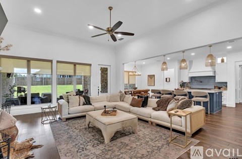 A spacious living room with a large sofa set and a coffee table.